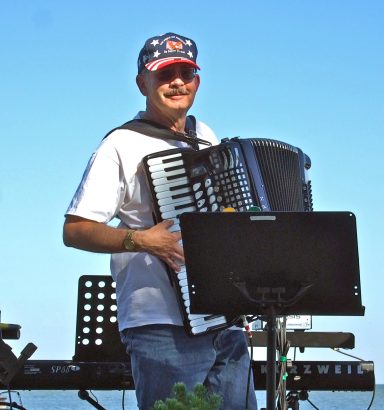 A picture of Tom Brown playing with The Knight Kats in 2014